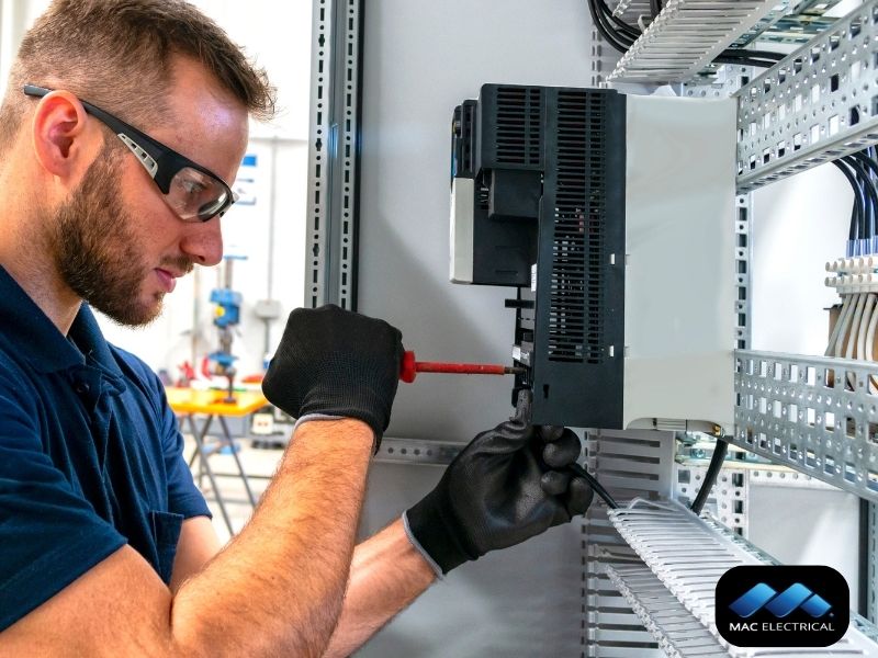 industrial electrician fixing switchboard
